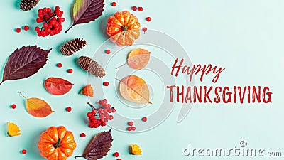Happy Thanksgiving greeting card with leaves, pumpkins, rowan berries on mint background. Fall, thanksgiving concept Stock Photo