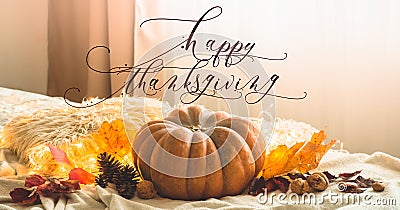 Happy thanksgiving text. In home decorated Pumpkin, cones, walnuts and autumn leaves garland. autumn fall holidays. Cozy mood Stock Photo