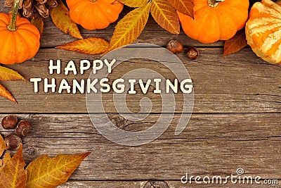 Happy Thanksgiving wooden letters with autumn corner border on wood Stock Photo