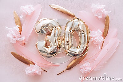 Happy birthday with golden number thirty 30 air balloons and feathers with colorful decorations on pink Stock Photo