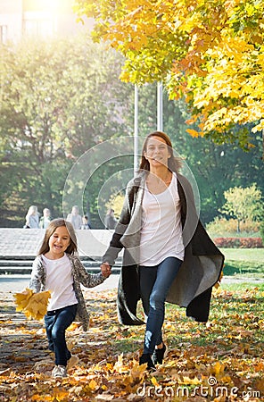 Happy time family and love abstract: mother and daughter run in autumn park Stock Photo