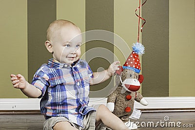 Happy Toddler Boy and Sock Monkey Stock Photo