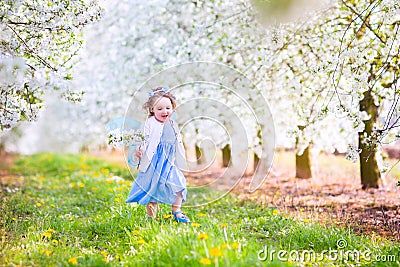 Happy toddlger girl in fairy costume in blooming garden Stock Photo