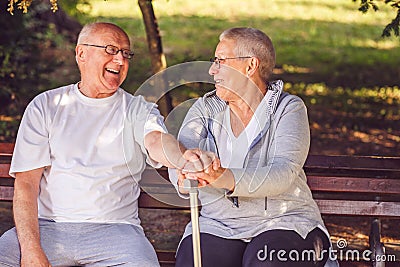 Happy together. Delighted positive elderly couple looking at each other and smiling while feeling happy . Stock Photo