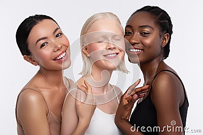 Cheerful women with different skin feeling happy together Stock Photo