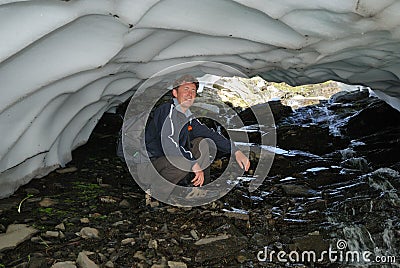 Happy tourist inside of the melting snowfield Stock Photo