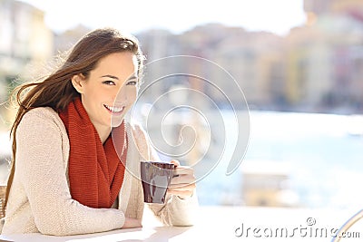 Happy tourist looking camera holding coffee cup Stock Photo