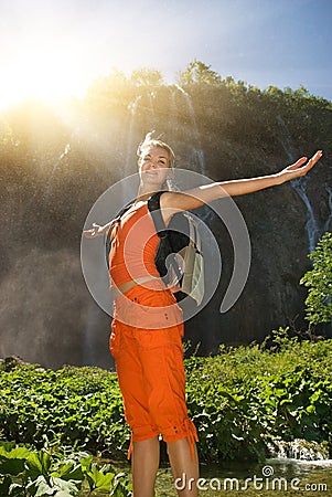 Happy tourist near waterfall Stock Photo