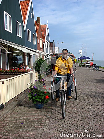 A Happy Tourist riding the bike taxi, Volendam Editorial Stock Photo