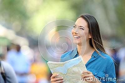 Happy tourist sightseeing holding a guide Stock Photo