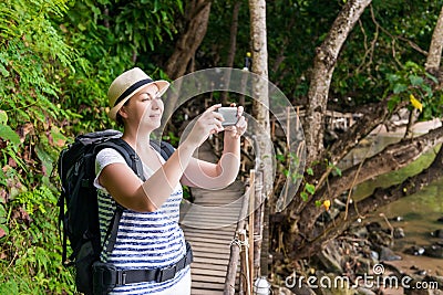 Happy tourist on vacation photographs beautiful landscapes Stock Photo