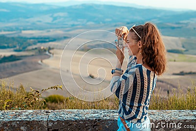 Happy tourist woman taking photos with retro photo camera Stock Photo