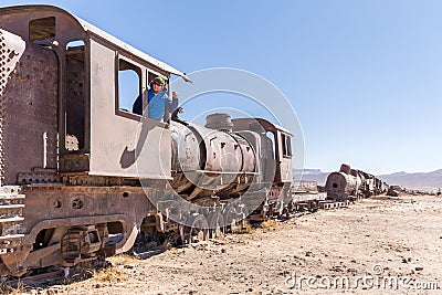 Happy train locomotive driver waving hello, Bolivia trains cemetery Stock Photo