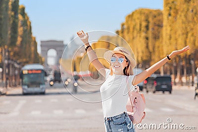 Traveler girl in the background of the traffic on Avenue Champs elysÃ©es. Tourism and students in France and Paris Stock Photo