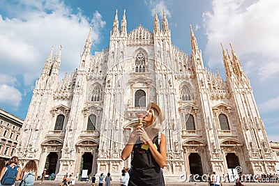 Happy traveler girl in Milan city. Tourist woman posing near Duomo cathedral in Milan, Italy, Europe Stock Photo