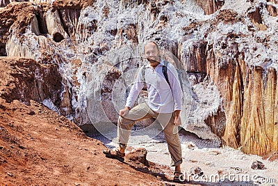 Happy traveler stands near the salty glacier, Hormuz Island, Ira Stock Photo