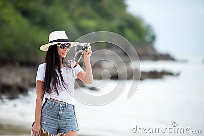 Happy traveler and tourism young women travel summer on the beach Stock Photo