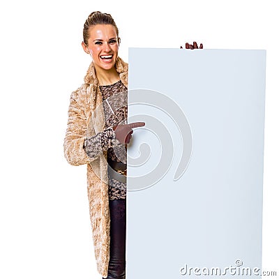 Happy trendy woman on white pointing at blank board Stock Photo