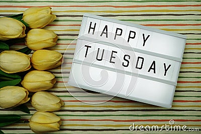 Happy Tuesday text in light box with space copy flat lay on colorful background Stock Photo