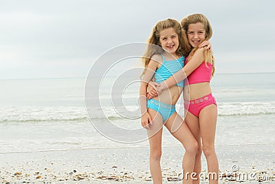 Happy twins at the beach Stock Photo