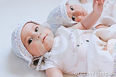 Happy twins in funny hats. Children girls 7 months Stock Photo
