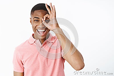 Happy uplifted and charismatic attractive young african american man smiling and laughing joyfully showing zero or okay Stock Photo