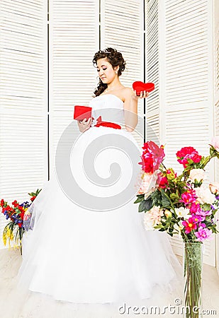 Happy Valentine's Day. Bride with red heart. Wedding and Valentine concept. Stock Photo
