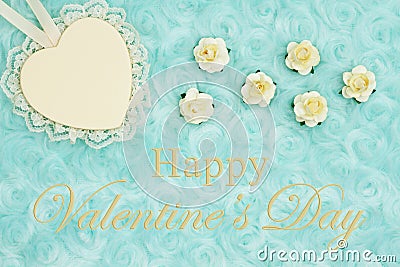 Happy Valentine`s Day greeting with a heart with lace on pale teal rose plush fabric Stock Photo