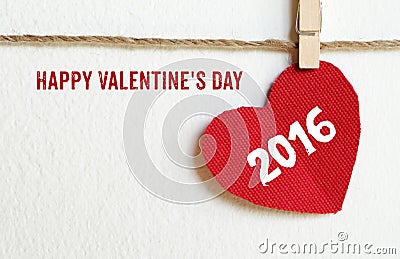 Happy valentine's day and red fabric heart shape hanging on cloth line background Stock Photo