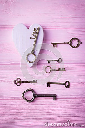 Vintage keys collection and pink heart. Key Love and key Dream on the pink background. Top view, free space Stock Photo