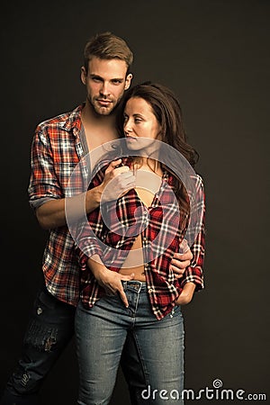 Happy valentines day. Man and girl passionate couple. Couple in love. Sexy couple taking off shirts. Intimate Stock Photo