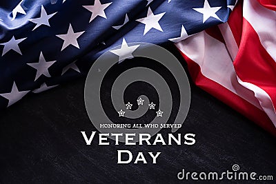 Happy Veterans Day. American flags with the text thank you veterans against a blackboard background. November 11 Stock Photo