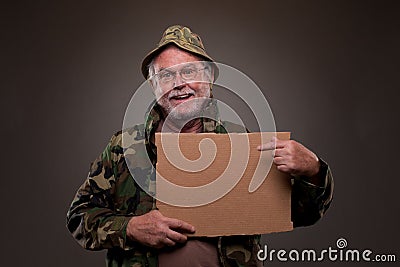 Happy Vietnam Veteran showing a cardboard piece Stock Photo
