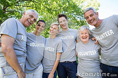 Happy volunteer family smiling at the camera Stock Photo