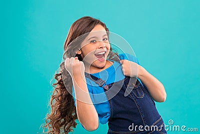 Happy winner. Successful happy kid. Achieve success. Kid cheerful celebrate victory. Girl cute child long curly hair Stock Photo