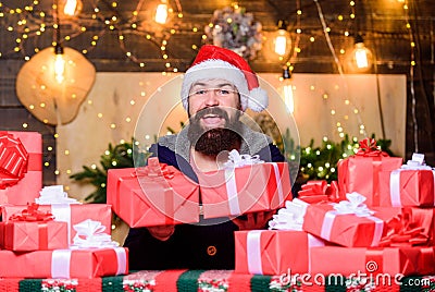 Happy winter holidays. Lot of gifts. Hipster prepared gifts for family. Man santa claus hat celebrate new year. Generous Stock Photo