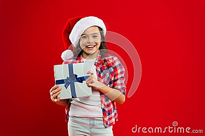 Happy winter holidays. Small girl. Present for Xmas. Childhood. Christmas shopping. Little girl child in santa red hat Stock Photo