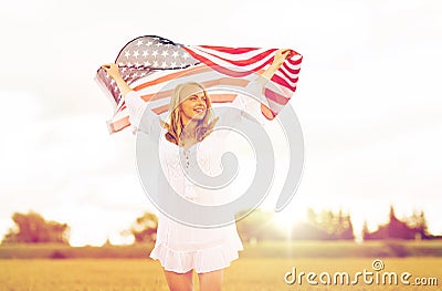 Happy woman with american flag on cereal field Stock Photo