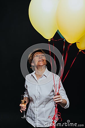 Happy woman with balloons and wineglass Stock Photo