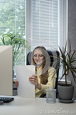 Happy woman boss after signing a contract. Director checked all the reports. Secretary prepared documents Stock Photo