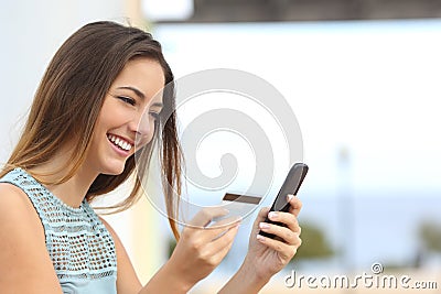 Happy woman buying online with a smart phone Stock Photo