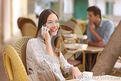 Happy woman calling on the phone in a restaurant Stock Photo