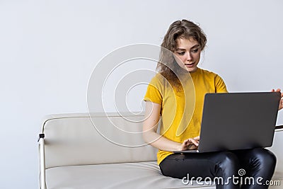 Happy woman chatting online on laptop. Smiling blonde woman messaging with friends on computer. Social media, communication and Stock Photo