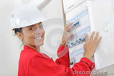 happy woman checking fuseboard Stock Photo