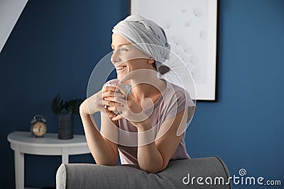 Happy woman after chemotherapy drinking tea at home Stock Photo