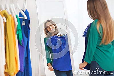 Happy woman choosing clothes at home wardrobe Stock Photo