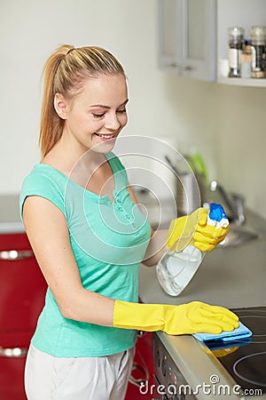 Happy woman cleaning cooker at home kitchen Stock Photo