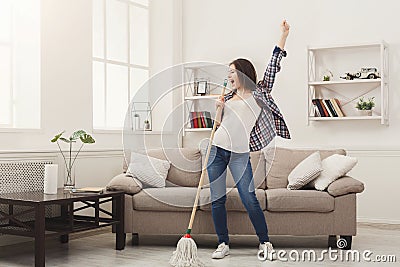 Happy woman cleaning home with mop and having fun Stock Photo