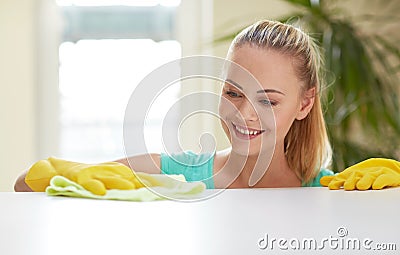 Happy woman cleaning table at home kitchen Stock Photo