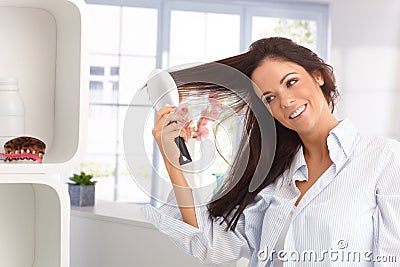 Happy woman combing hair Stock Photo